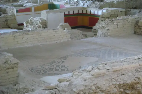 Resti archeologici a Castelleone di Suasa con un antico mosaico sul pavimento e affreschi colorati sulle pareti.